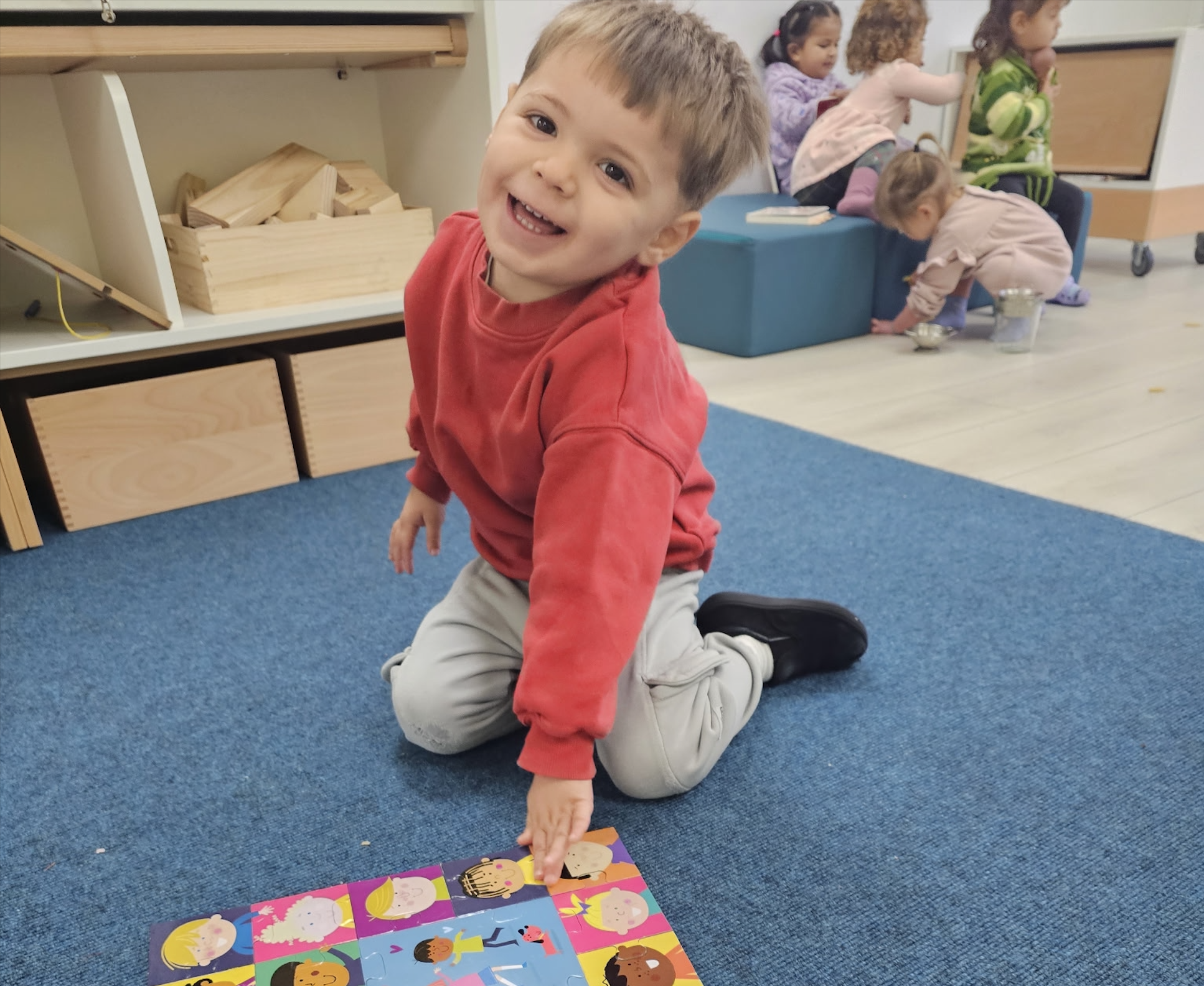 The indoor classroom — open, light-filled space with Montessori shelving and learning areas