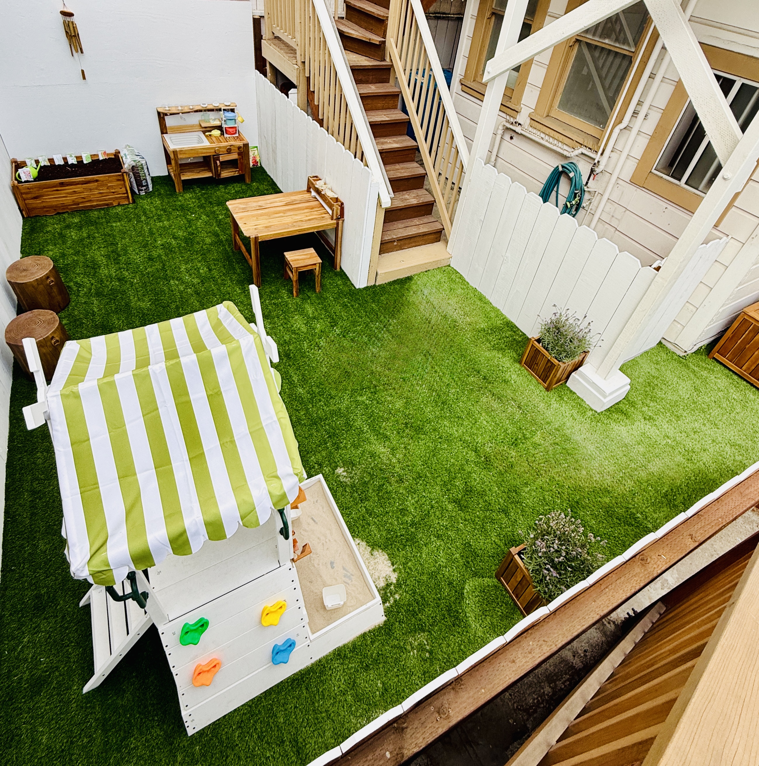 Children tending raised garden beds in the outdoor classroom